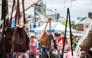 Market stall selling bags with view of shoppers